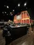 The image shows a view of the Grand Ole Opry stage with musical instruments set up for a performance, framed by the venue's iconic barn-like backdrop.