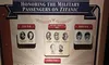 The image shows a memorial display honoring military passengers on the Titanic, categorized by the conflicts they were associated with such as the Civil War, Spanish-American War, Boer War, World War I, and beyond.