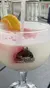 A frosty cocktail with a slice of orange and a plastic straw is served in a glass featuring the logo for the General Jackson Showboat in Nashville, Tennessee.