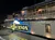 The image shows the ornately designed side of a riverboat at night, illuminated by lights, with