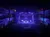 The image captures a live performance on a theater stage with illuminated decorations and a captivated audience.