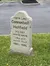 The image shows a humorous mock grave marker for