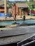 Competitors in a lumberjack contest are engaging in a log rolling event in a water-filled arena.