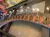 A creative display featuring a row of guitars mounted on a wall with lightbulbs installed at their center, creating an intriguing fusion of musical and lighting elements.