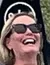 A person is joyfully riding a mountain coaster, laughing as they descend along the track.