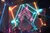 The image shows a colorful stage with neon lighting and geometric visuals, where two musicians are performing in the foreground.