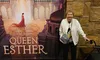 A smiling person stands in front of a backdrop advertising the theatrical production