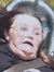 A person is experiencing a thrilling moment on a roller coaster, with their hair flying back and a facial expression of intense emotion.