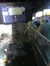 Visitors are observing marine life in an indoor aquarium exhibit, with information about sea water contents displayed on a panel above.
