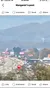The image shows a busy road with colorful storefront signs, a visible cell signal indicator with 