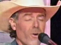 A group of musicians in cowboy hats perform on stage with various instruments in a festive setting.
