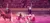 Santa Claus is riding in a sleigh pulled by a horse in an arena, observed by an audience seated in wooden balconies.