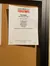 The image shows a bulletin board with a poster advertising an