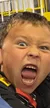 The image shows a child making an exaggerated, playful yelling face, likely in excitement or fun.