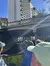 A group of people on a boat are passing under a bridge marked