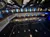 The image depicts an upside-down view of a theater or auditorium with rows of seats, balconies, and a stage.