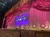 The image shows a theater stage with an ornate red curtain and a projected screen announcing the availability of digital soundtracks.