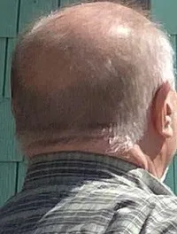 The image shows a man approaching a tiki-themed entrance of
