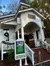 The image shows a quaint chapel with holiday decorations and a sign advertising