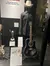 The image shows a museum display featuring a cowboy hat and shirt, a guitar with a