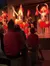 Dancers in vibrant traditional attire perform energetically on stage as an audience watches.