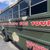 The image shows a green bus with
