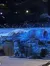 The image shows a stage set featuring a rocky landscape under a starry, nighttime sky.
