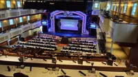 The image shows a theater-style interior with a stage labeled 