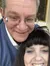 A man and a woman are smiling closely together for a selfie.