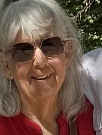 An older couple is standing together beneath an ornate 