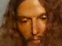 The image shows a theatrical scene with three people in biblical costumes, including one in a shiny robe, set against a backdrop of clouds.