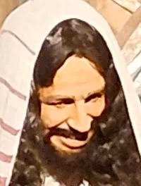 The image depicts a lifelike scene with mannequins dressed in historical attire, posing in front of a stone building, resembling a biblical or ancient setting.