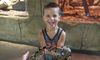 Young Boy with a Snake at RainForest Adventures Discovery Zoo