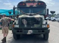 A camouflaged bus labeled