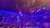 The image shows an elaborate stage set with an Arabian theme, featuring colorful hanging lanterns, intricate architectural facades, and a gathering audience below.