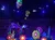 A stage is adorned with vibrant, oversized flowers and butterflies under colorful lighting, with an audience seated in the background.