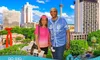 A couple poses for a photo with a city skyline in the background, and there's a banner for Go Rio San Antonio River Cruises at the bottom.