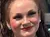 A little girl poses with three performers in patriotic-themed costumes in front of a 