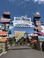 The image shows a lively entrance sign for