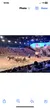 The image shows an indoor arena with an audience watching a live Western-themed performance featuring horses, wagons, and riders.