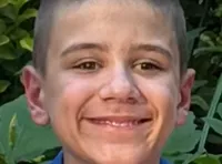 A group of four people is smiling in front of the 