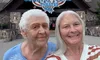 Two women are smiling in front of the Country Tonite Theatre building.