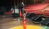 The image shows the iconic stage and microphone setup of the Grand Ole Opry in a theater with red seating and bright lights.