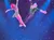 Two acrobats are performing a synchronized aerial silk routine on a stage with a starry background.