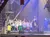 A group of performers dressed as pirates, along with children, are on stage during a theatrical show with a nautical theme.