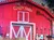 The image shows a stage set designed like a red barn with the sign 
