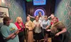 A group of people are posing together in a stylized room with a 