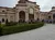 The image shows a grand building with domes and arches, featuring a 
