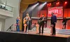 A group of musicians is performing on a stage labeled 