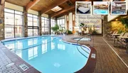 The image shows an inviting indoor pool area with wooden beams, stone accents, and lounge chairs, featuring text about amenities like free breakfast, an indoor pool, and an outdoor pool.